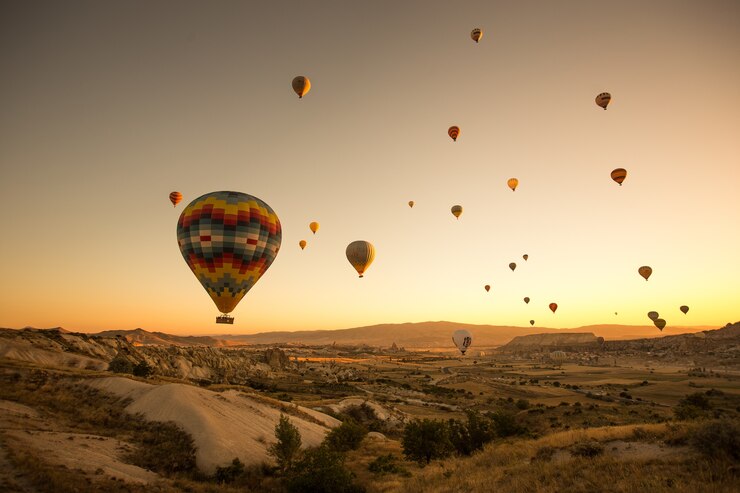 set-colored-balloons-flying-ground-cappadocia-turkey_181624-20938