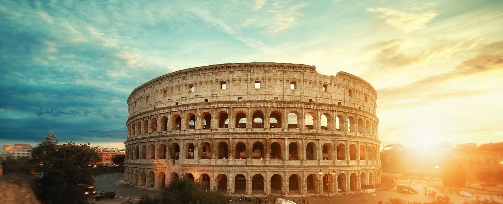 A beautiful shot of the famous Roman Colosseum amphitheater under the breathtaking sky at sunrise