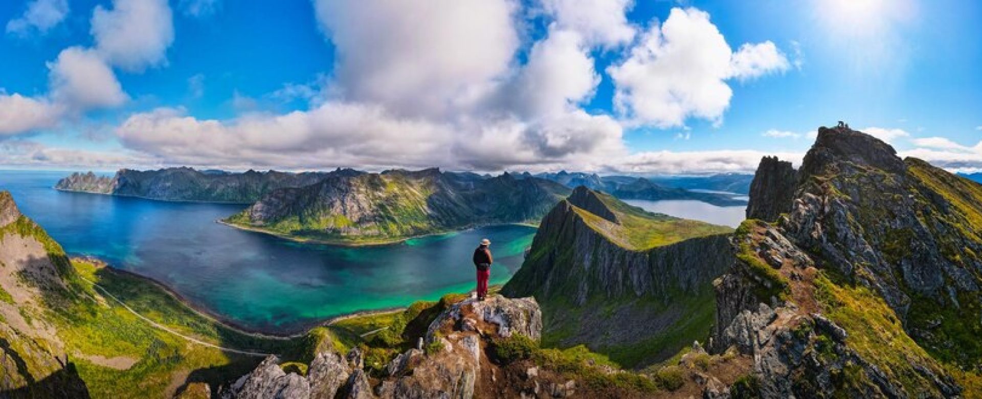 hiker-standing-top-husfjellet-mountain-senja-island-norway_165988-2929