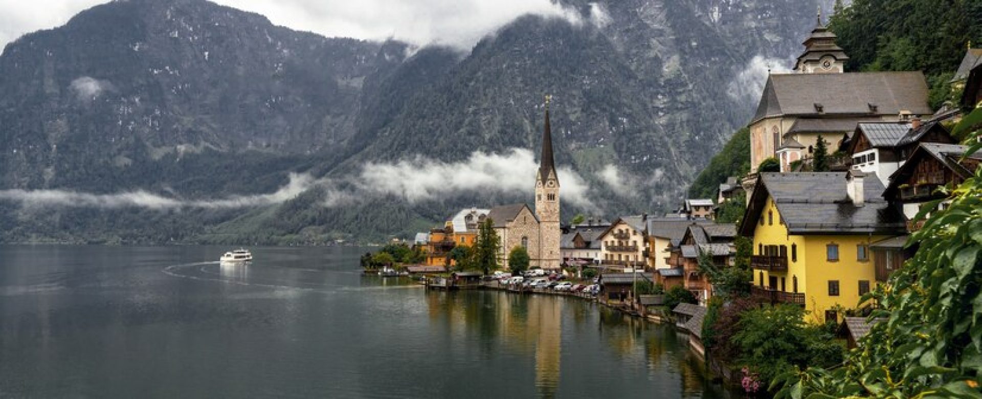 landscape-hallstatt-surrounded-by-water-rocky-mountains-rainy-day-austria_181624-45852