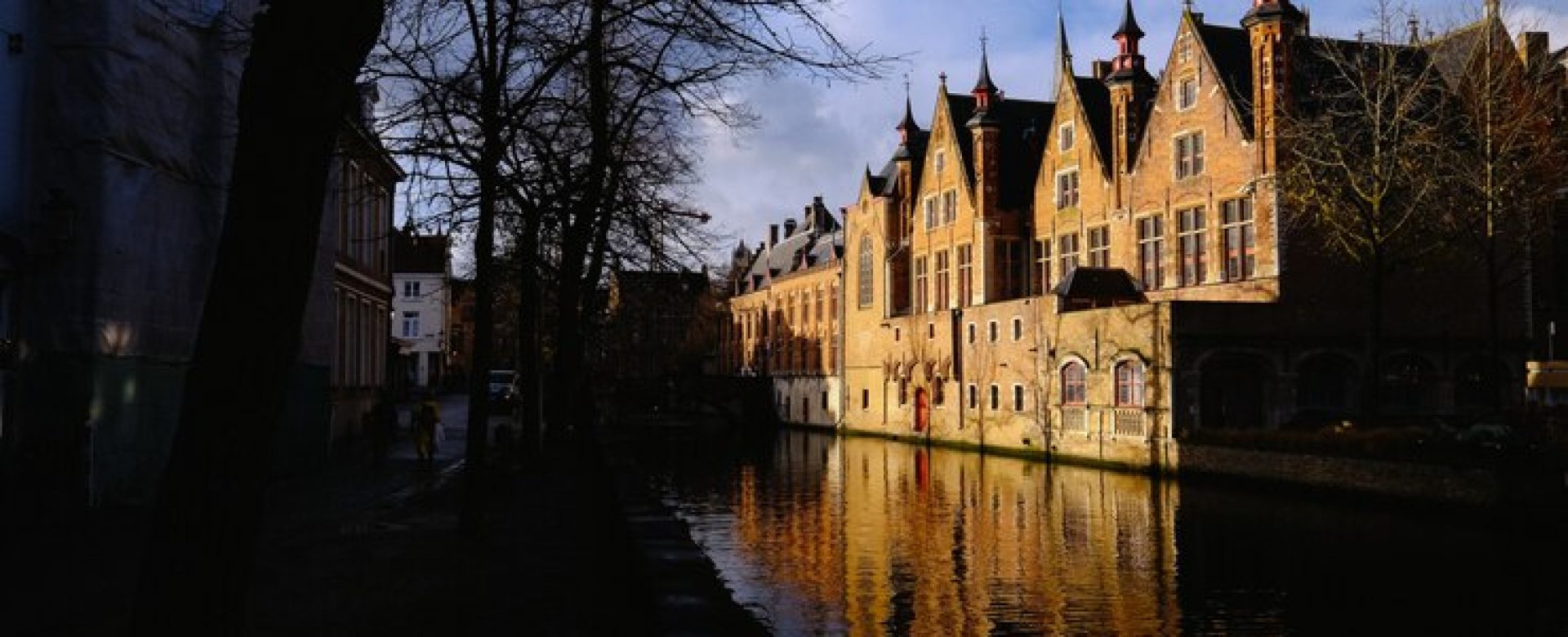 people-walking-sidewalk-near-canal-middle-buildings_181624-1748