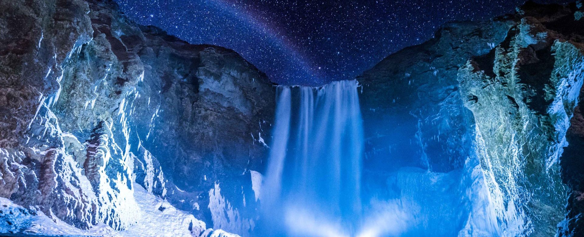 person-front-waterfalls-nighttime (1)