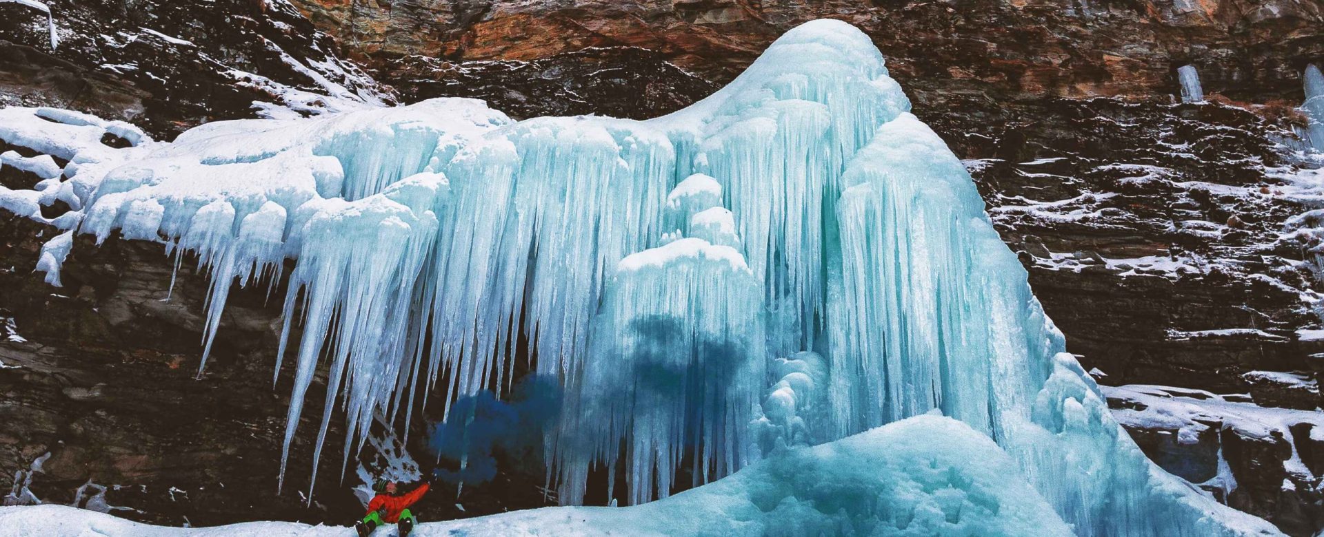 person-sits-mountain-with-icicles