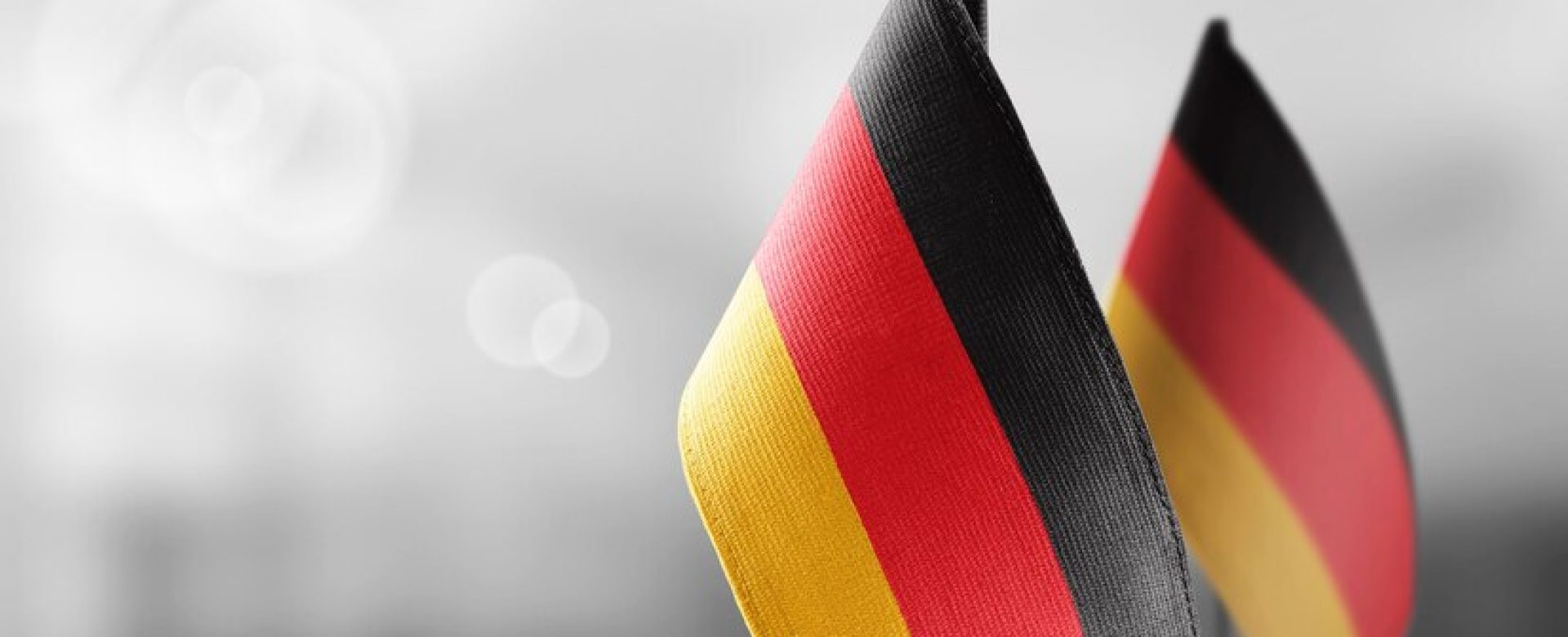 small-national-flags-germany-light-blurry-wall_485709-4